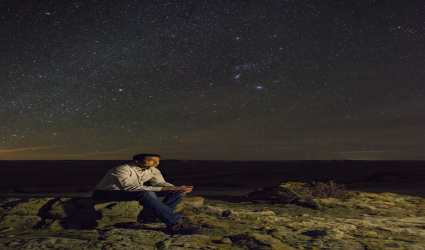 Man sitting under the stars