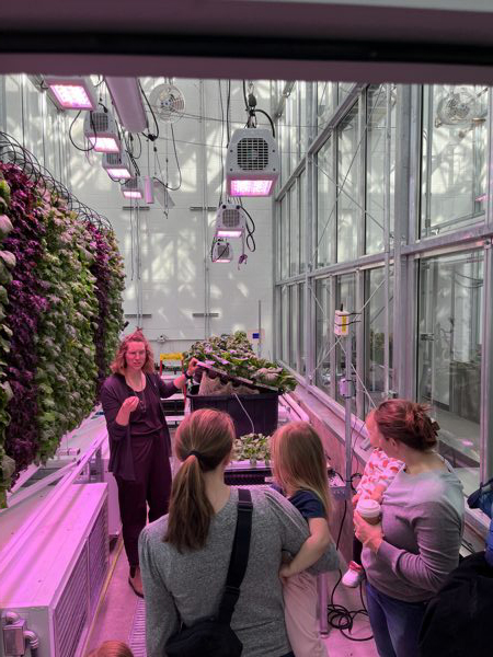 Teacher teaching children in plant facility