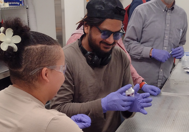 Researchers in lab with gloves on