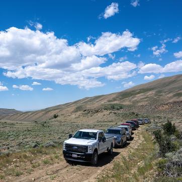 Trucks driving on dirt road