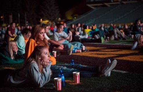 Students watching movie at War Memorial Stadium