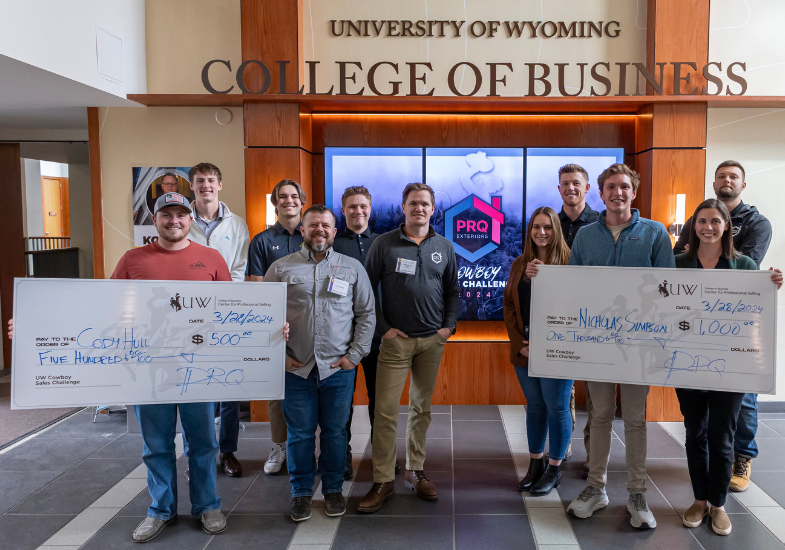 sales competiton winners with large checks