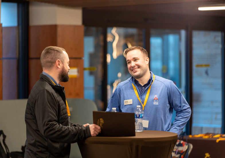 a student chats with an emplyer partner at a networking event