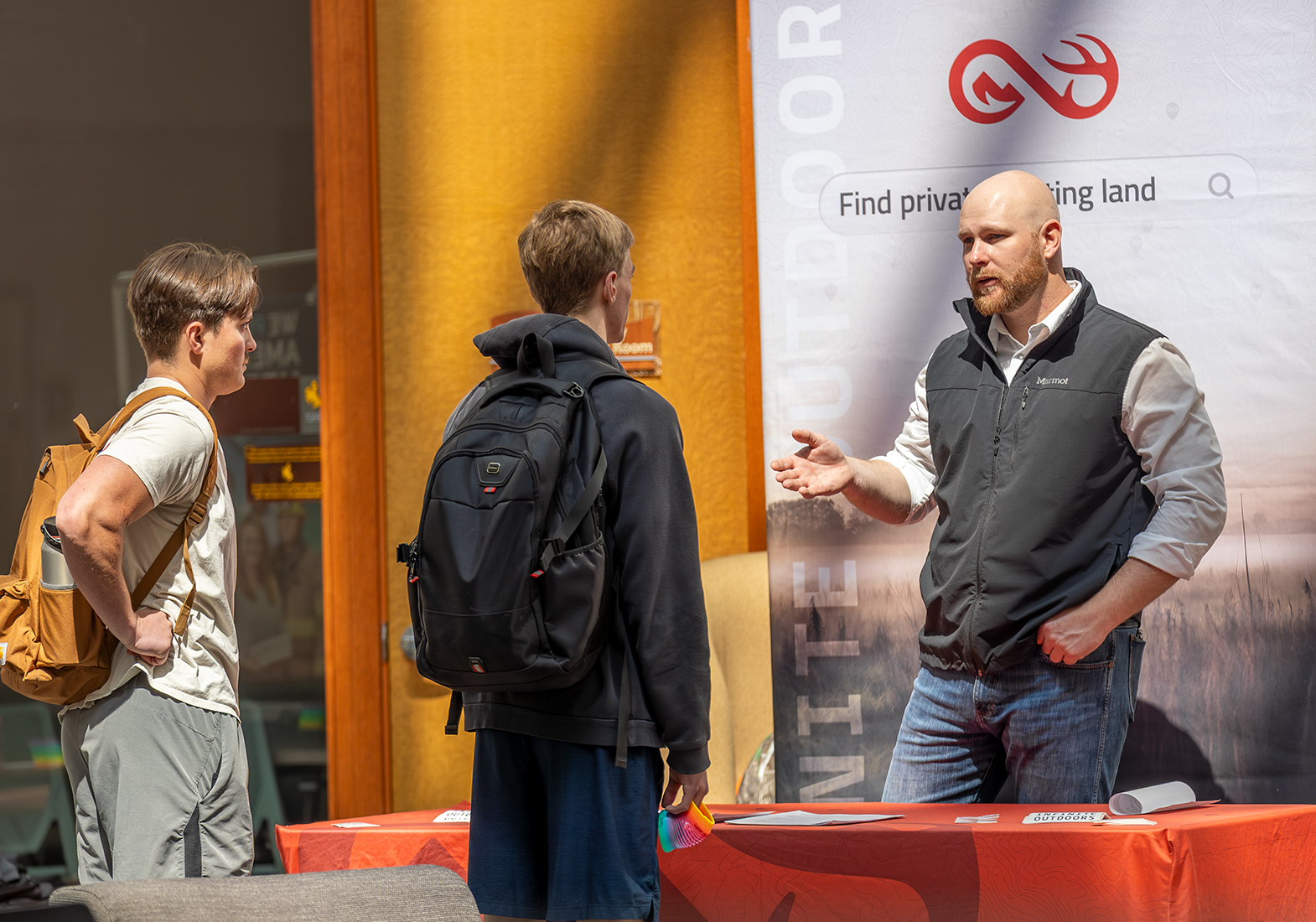 Students chat with an emplyer partner at a networking event