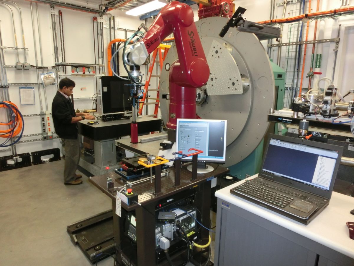 male research working on sample exchange robot at Square One System & Design Inc.