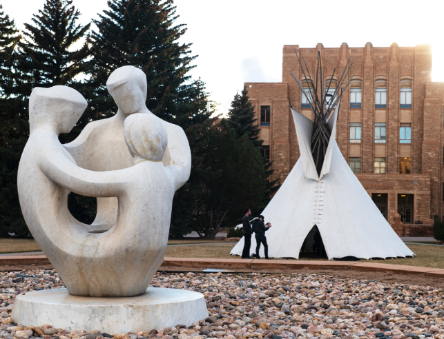 Prexy's pasture showing family sculpture and teepee