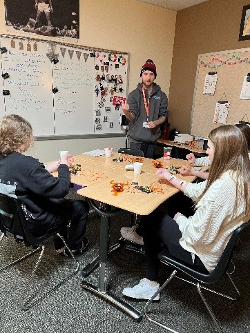 outreach assistant talking with group of students