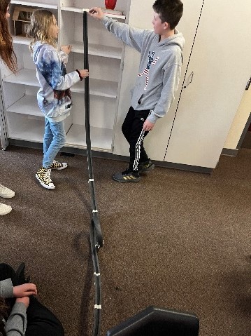 students testing marble at top of roller coaster