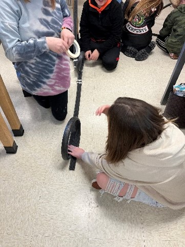 students making loop in roller coaster