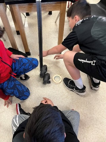 students making a roller coaster with two loops