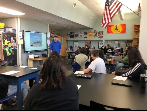 outreach assistant speaks with students