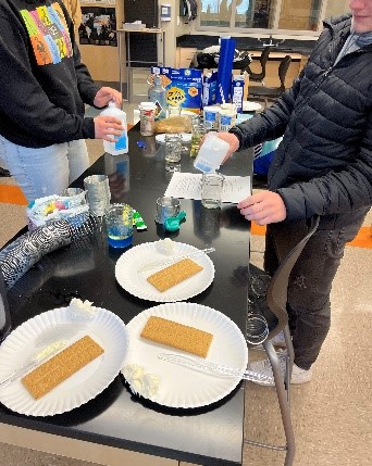 students working with graham crackers and frosting