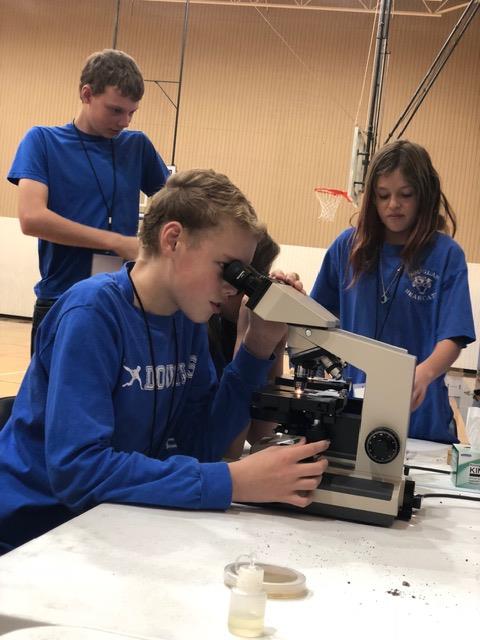 Two Douglas students looking into a microscope