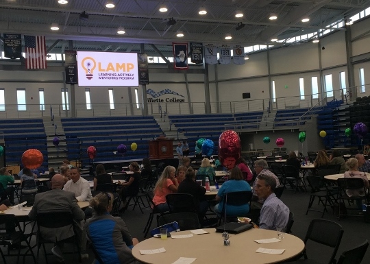 crowd at tables in gymnasium