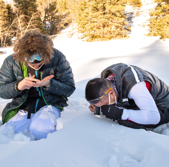 Two skiiers observing snow