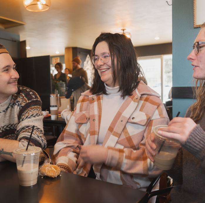 students interacting with each other in coffee shop