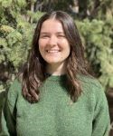 Scientist with dark hair in green sweater
