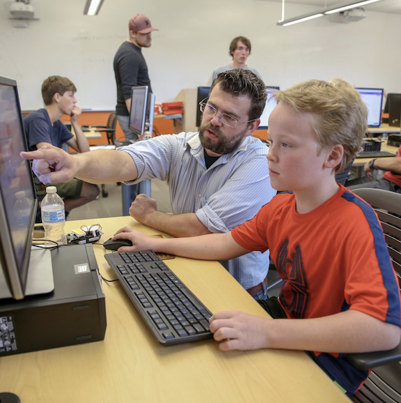 Dr. Borowczak helps a student.