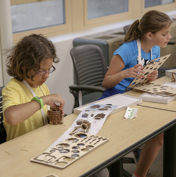 Two students work on a project
