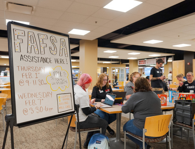 Student Success Service TRIO advisors help students with their FAFSA application in the Wyoming Union