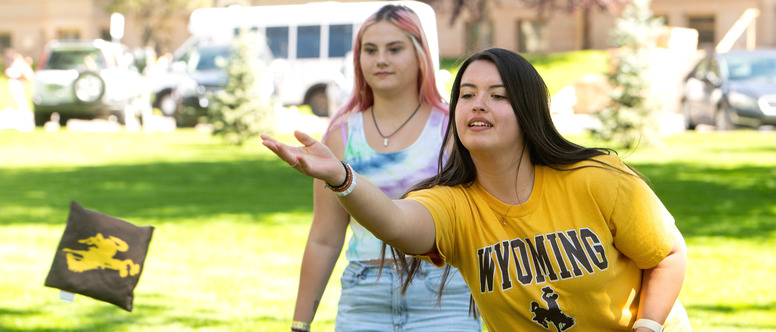 Two students playing cornhole at the SSS Welcome Back BBQ in 2023.
