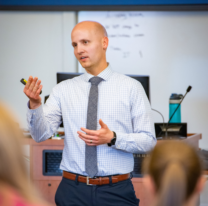 Image of a professor lecturing to students. 