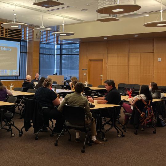 A group of people watch a presentation at the 2023 National First-Generation College Student Celebration Day. 