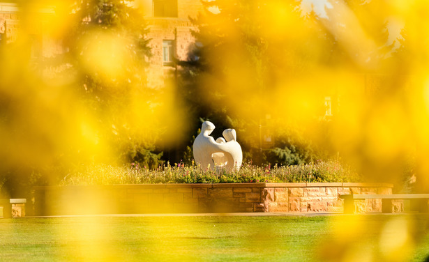Image of statue in Prexy's Pasture between leaves.
