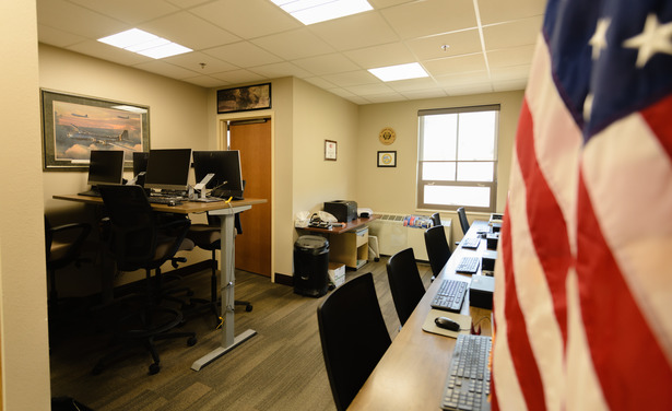 Image of computer lab with American flag in the bottom corner.