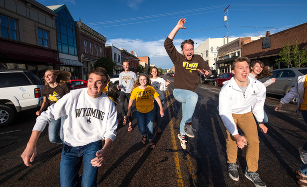 A group of UW students running along Grand Ave. in downtown Laramie. 