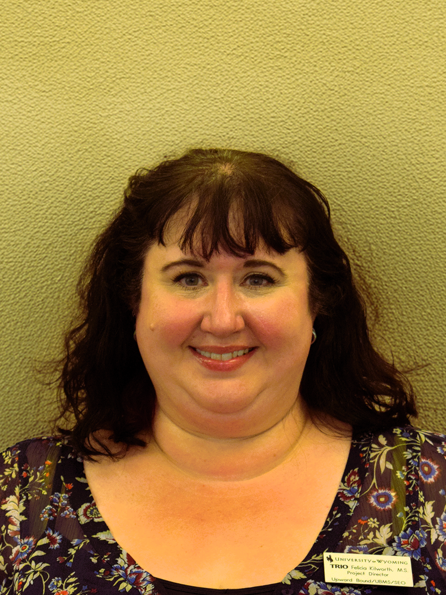 Felicia Killworth stands in front of a beige wall.