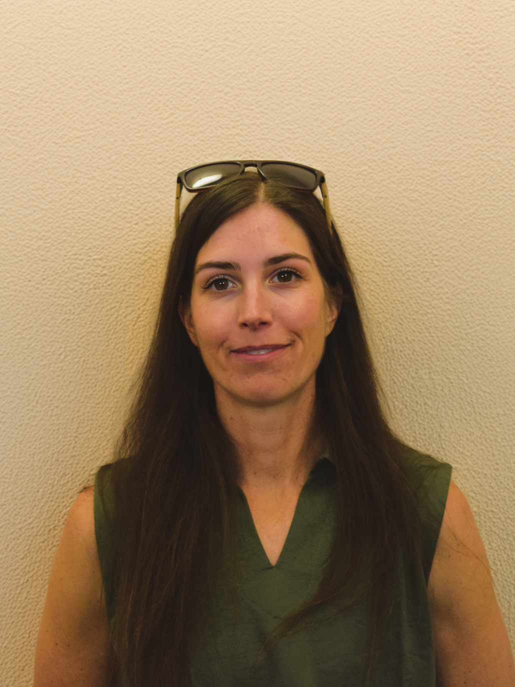 Paula Vincelette stands in front of a beige wall.