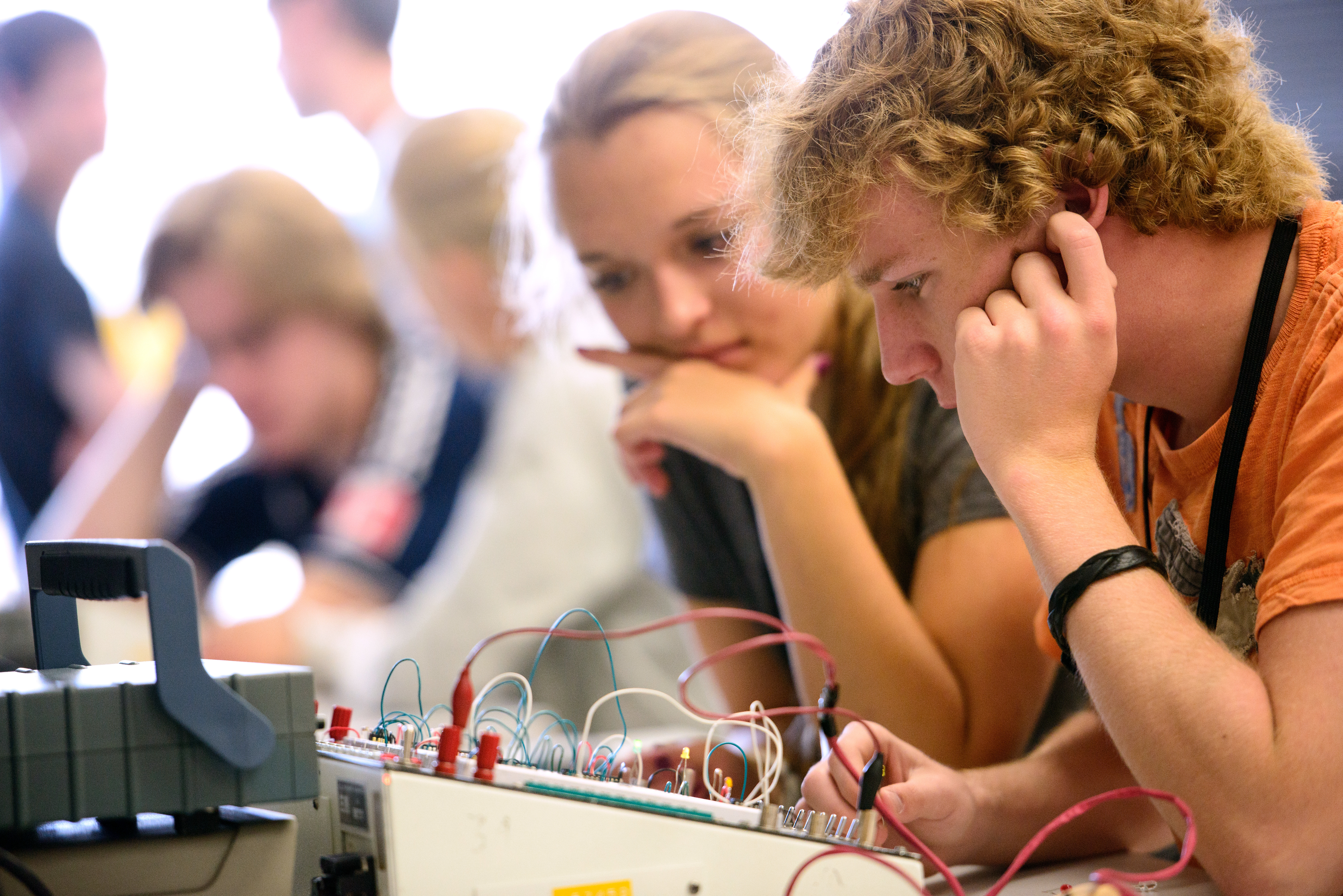 Students working with a circuit board.