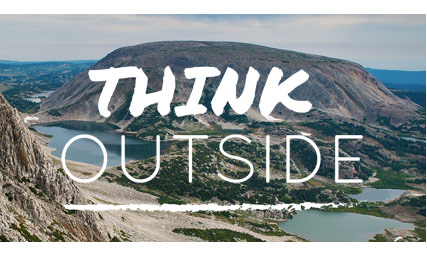 think outside text in front of mountain scene