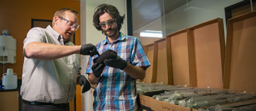 two people looking at a core sample