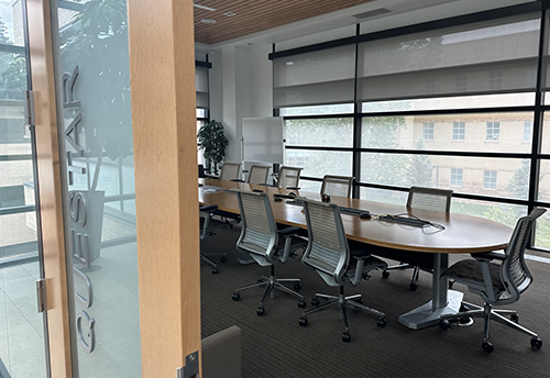 well lit boardroom room with conference table in center