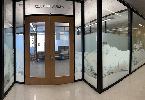 Doors and glass walls covered by a transparent wrap with the Williams logo