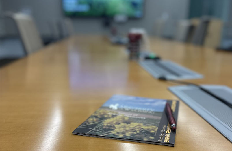 ermd booklet and pen on top of a board room table