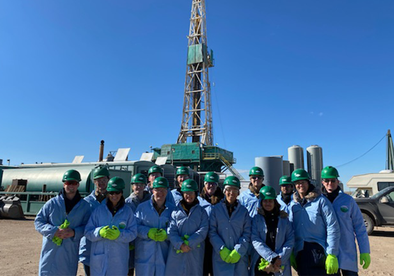 students in front of an oil rig on a field course