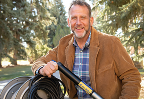 Michael Urynowicz holding equipment used in the Center