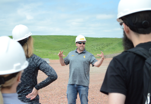 CEGR director speaking to a group of people in the field