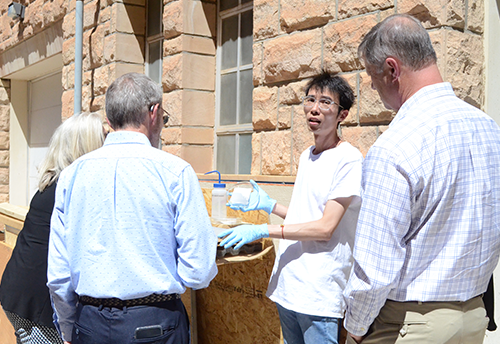 A graduate student showing coal-derived membrane filters to people