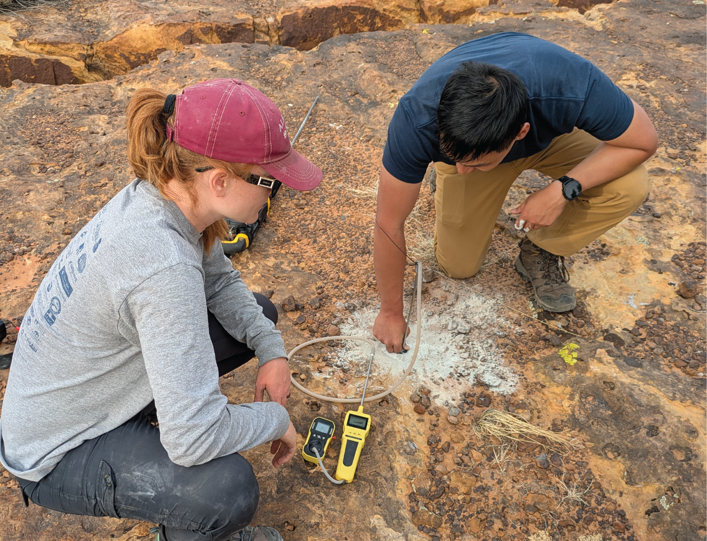 HERC team drilling a hole in the ground for testing