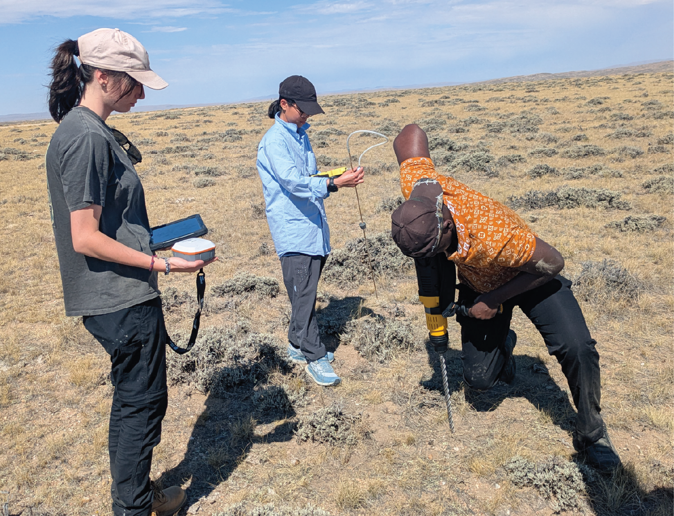 HERC team drilling a hole in the ground for testing