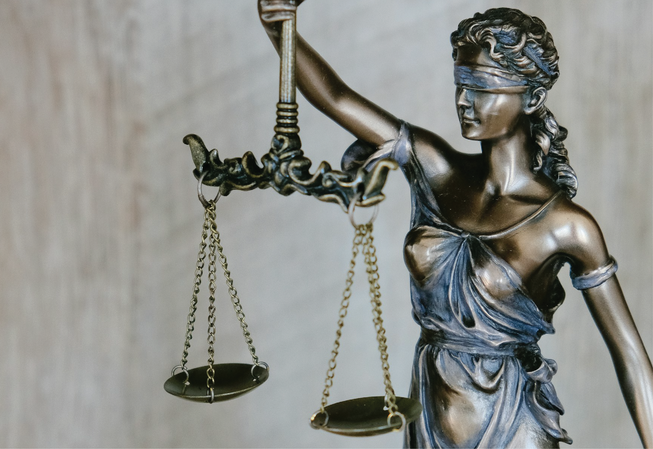 bronze statue of lady law holding a scale