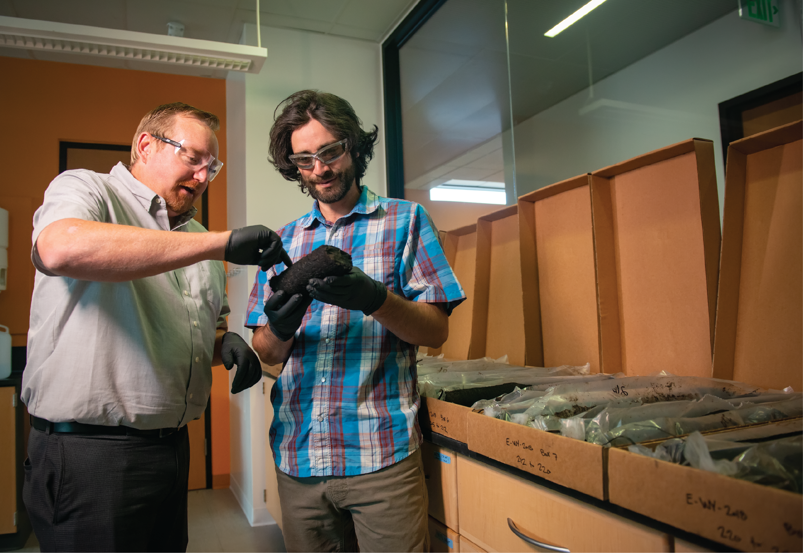 Two research scientists looking at coal