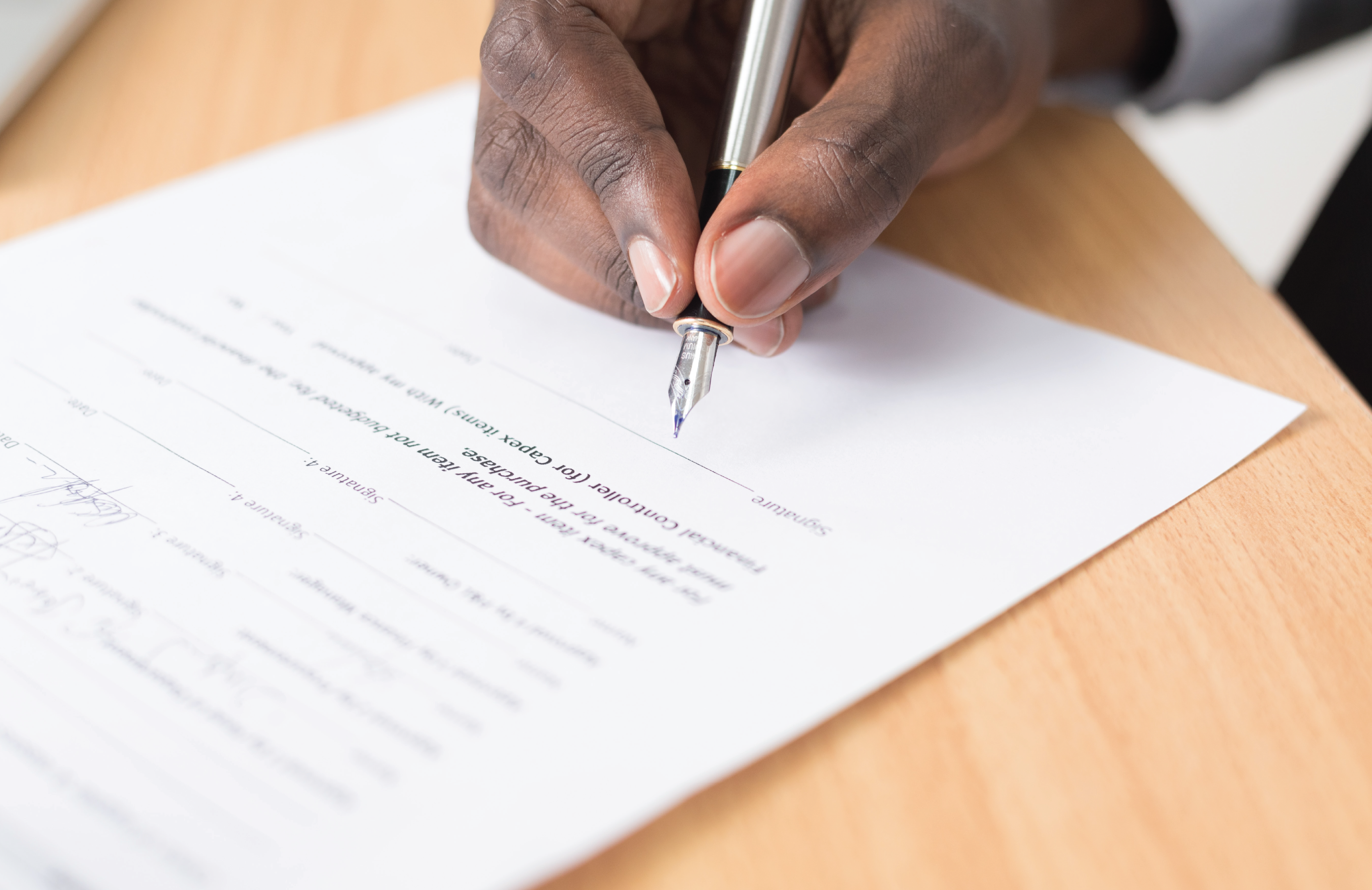signing a paper stock photo
