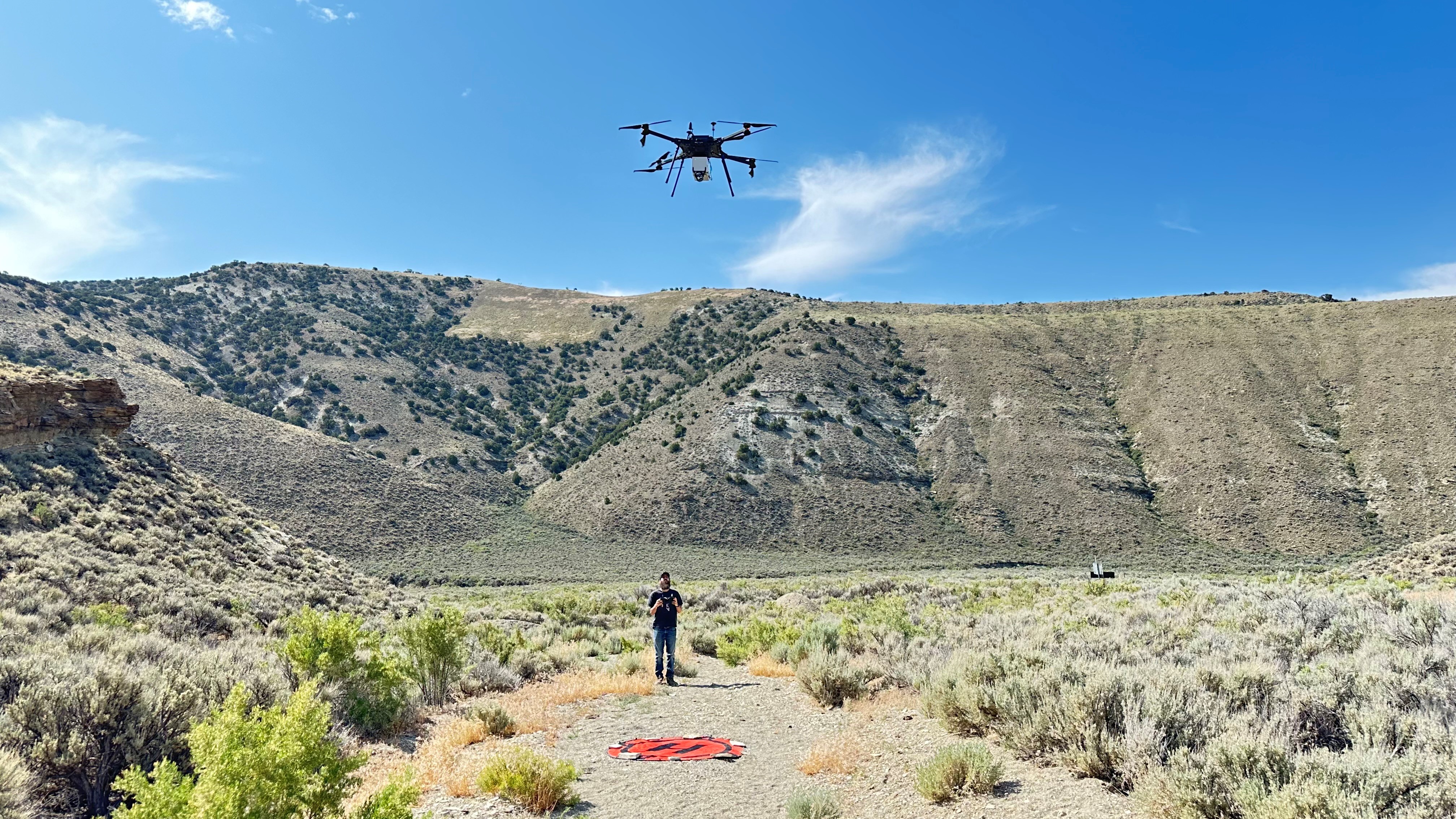 team in behind drone