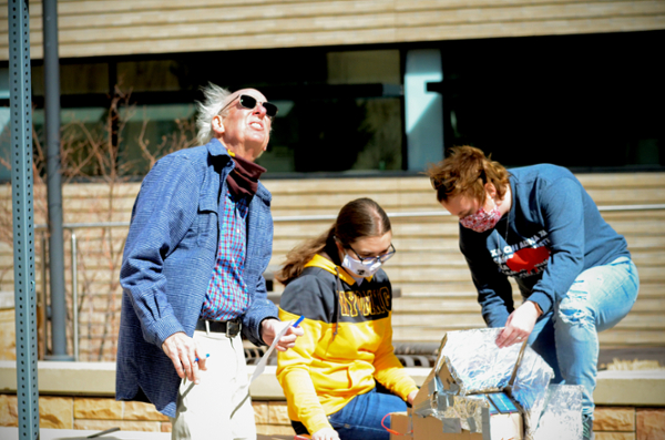 students work on solar project outside