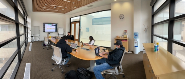 students in class listening to a conference call